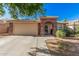 Charming single-story home featuring a stucco facade, a two car garage and desert landscaping at 17532 W Caribbean Ln, Surprise, AZ 85388