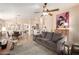 Open concept living room featuring a ceiling fan and views of the dining room at 17532 W Caribbean Ln, Surprise, AZ 85388