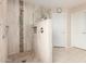 Main bathroom shower features stylish tile surround, bench seating, and glass partition at 17532 W Caribbean Ln, Surprise, AZ 85388