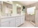 Lovely main bathroom features double sinks, sleek vanity, and decorative window accents at 17532 W Caribbean Ln, Surprise, AZ 85388