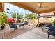 Outdoor patio area with comfortable seating, complemented by lush greenery and landscaping at 17532 W Caribbean Ln, Surprise, AZ 85388