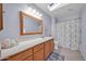 Bathroom featuring a spacious vanity, tile floor, and a well-lit skylight at 18254 N 136Th Ave, Sun City West, AZ 85375