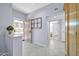 Bright entryway with tile flooring, secure front door, and view into the living spaces at 18254 N 136Th Ave, Sun City West, AZ 85375