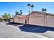 Detached garages on a neighborhood street with mature palm trees, providing ample parking space at 18254 N 136Th Ave, Sun City West, AZ 85375