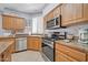 Inviting kitchen with stainless steel appliances, granite countertops, and bright natural light from the windows at 18254 N 136Th Ave, Sun City West, AZ 85375