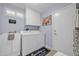 Functional laundry room featuring a washing machine, dryer, utility sink, and storage cabinets at 18254 N 136Th Ave, Sun City West, AZ 85375