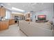 Bright and airy living room and kitchen featuring stainless steel appliances and a comfortable sectional sofa at 18254 N 136Th Ave, Sun City West, AZ 85375