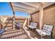 Cozy outdoor patio with a pergola, seating arrangement, and brick flooring at 18254 N 136Th Ave, Sun City West, AZ 85375