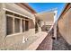 Backyard area features an outdoor patio with pergola, small pavers, and a sliding glass door entrance at 18254 N 136Th Ave, Sun City West, AZ 85375