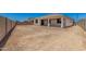A spacious backyard featuring a covered patio and block wall surrounding the property at 18347 W Monte Lindo Ln, Surprise, AZ 85387