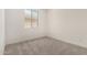 This light-filled bedroom features neutral carpet and one window that adds natural light at 18347 W Monte Lindo Ln, Surprise, AZ 85387
