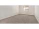 New carpet and a window define this otherwise empty bedroom at 18347 W Monte Lindo Ln, Surprise, AZ 85387
