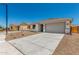 Charming single-story home with desert landscaping, concrete driveway, and attached garage at 18347 W Monte Lindo Ln, Surprise, AZ 85387