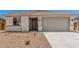 Charming single-story home showcasing desert landscaping, a gray garage door, and a tiled roof at 18347 W Monte Lindo Ln, Surprise, AZ 85387