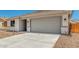 Single-story home featuring desert landscaping, concrete driveway, and neutral-colored exterior at 18347 W Monte Lindo Ln, Surprise, AZ 85387
