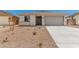 Single-story home featuring desert landscaping, concrete driveway, and neutral color palette at 18347 W Monte Lindo Ln, Surprise, AZ 85387