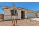 Single-story home featuring desert landscaping, concrete driveway, and neutral color palette at 18347 W Monte Lindo Ln, Surprise, AZ 85387