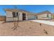 Single-story home with desert landscaping, concrete driveway, and neutral-colored exterior at 18347 W Monte Lindo Ln, Surprise, AZ 85387