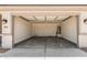 Spacious two-car garage showcasing ample parking and storage, illuminated by modern lighting at 18347 W Monte Lindo Ln, Surprise, AZ 85387