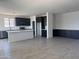 Bright kitchen featuring dark brown cabinets, white countertops, stainless steel appliances, and an island at 18347 W Monte Lindo Ln, Surprise, AZ 85387