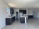 Bright kitchen featuring dark brown cabinets, white countertops, an island, and a pantry at 18347 W Monte Lindo Ln, Surprise, AZ 85387