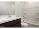 Bathroom with a white vanity, a modern sink and a shower and tub combination at 18363 W Monte Lindo Ln, Surprise, AZ 85387