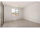 Bedroom featuring hard surface floors, a window, and a glass sliding door at 18363 W Monte Lindo Ln, Surprise, AZ 85387