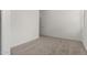 Neutral-toned bedroom showcasing a large window and carpet flooring at 18363 W Monte Lindo Ln, Surprise, AZ 85387
