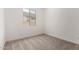 A bright bedroom with carpet, neutral walls, and a large window for natural light at 18363 W Monte Lindo Ln, Surprise, AZ 85387