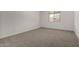 Bedroom with carpet, a window with a view, and white trim at 18363 W Monte Lindo Ln, Surprise, AZ 85387