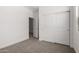 Neutral bedroom featuring a closet with sliding doors and nearby doorway at 18363 W Monte Lindo Ln, Surprise, AZ 85387