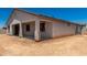 Exterior view of back of home with covered patio at 18363 W Monte Lindo Ln, Surprise, AZ 85387