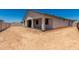 Exterior view of back of home with covered patio at 18363 W Monte Lindo Ln, Surprise, AZ 85387