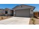 Lovely single-Gathering home boasts desert landscaping, a two-car garage, and a covered entryway at 18363 W Monte Lindo Ln, Surprise, AZ 85387