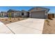 Attractive house with a well-manicured yard, long driveway, and a two-car garage at 18363 W Monte Lindo Ln, Surprise, AZ 85387