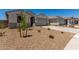 A beautiful single-story house with a two-car garage and desert landscaping at 18363 W Monte Lindo Ln, Surprise, AZ 85387