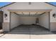 Spacious two-car garage with clean concrete floor and water heater at 18363 W Monte Lindo Ln, Surprise, AZ 85387