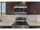 Modern stainless steel microwave and cooktop at 18363 W Monte Lindo Ln, Surprise, AZ 85387