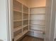 Walk-in pantry with ample shelving for organized storage at 18363 W Monte Lindo Ln, Surprise, AZ 85387