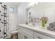 Bathroom showcases a white vanity, quartz countertop, and decorative shower curtain at 20180 W Highland Ave, Litchfield Park, AZ 85340