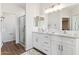 Bright bathroom featuring double vanity, modern fixtures, and a glass-enclosed shower at 20180 W Highland Ave, Litchfield Park, AZ 85340