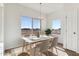 Sunlit dining area with large windows, stylish table setting, and modern chandelier at 20180 W Highland Ave, Litchfield Park, AZ 85340