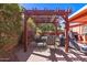 Cozy backyard patio featuring a dining area under a wooden pergola, perfect for outdoor entertaining and relaxation at 2101 S Meridian Rd # 60, Apache Junction, AZ 85120