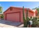 Side view of a charming home featuring a spacious two-car garage and well-maintained desert landscaping at 2101 S Meridian Rd # 60, Apache Junction, AZ 85120