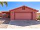 Charming single-story home with a two-car garage, covered porch, and desert landscaping in front at 2101 S Meridian Rd # 60, Apache Junction, AZ 85120