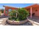 Charming desert landscaping surrounds the front of this single-story home with covered front porch at 2101 S Meridian Rd # 60, Apache Junction, AZ 85120