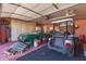 This is an organized garage with a vintage vehicle, golf cart, and lots of wooden storage cabinets at 2101 S Meridian Rd # 60, Apache Junction, AZ 85120