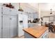 Bright kitchen showcasing white cabinetry, appliances, and wooden island with glass top at 2101 S Meridian Rd # 60, Apache Junction, AZ 85120