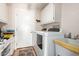 This is a spacious laundry room with tile flooring, white cabinets, and a large sink at 2101 S Meridian Rd # 60, Apache Junction, AZ 85120