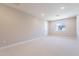 Bright, carpeted bedroom with neutral walls, recessed lighting, and a window for natural light at 2121 W Sonoran Desert Dr # 47, Phoenix, AZ 85085